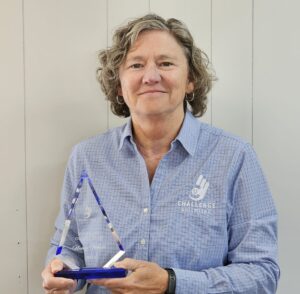 Nancy is shown holding her award. 